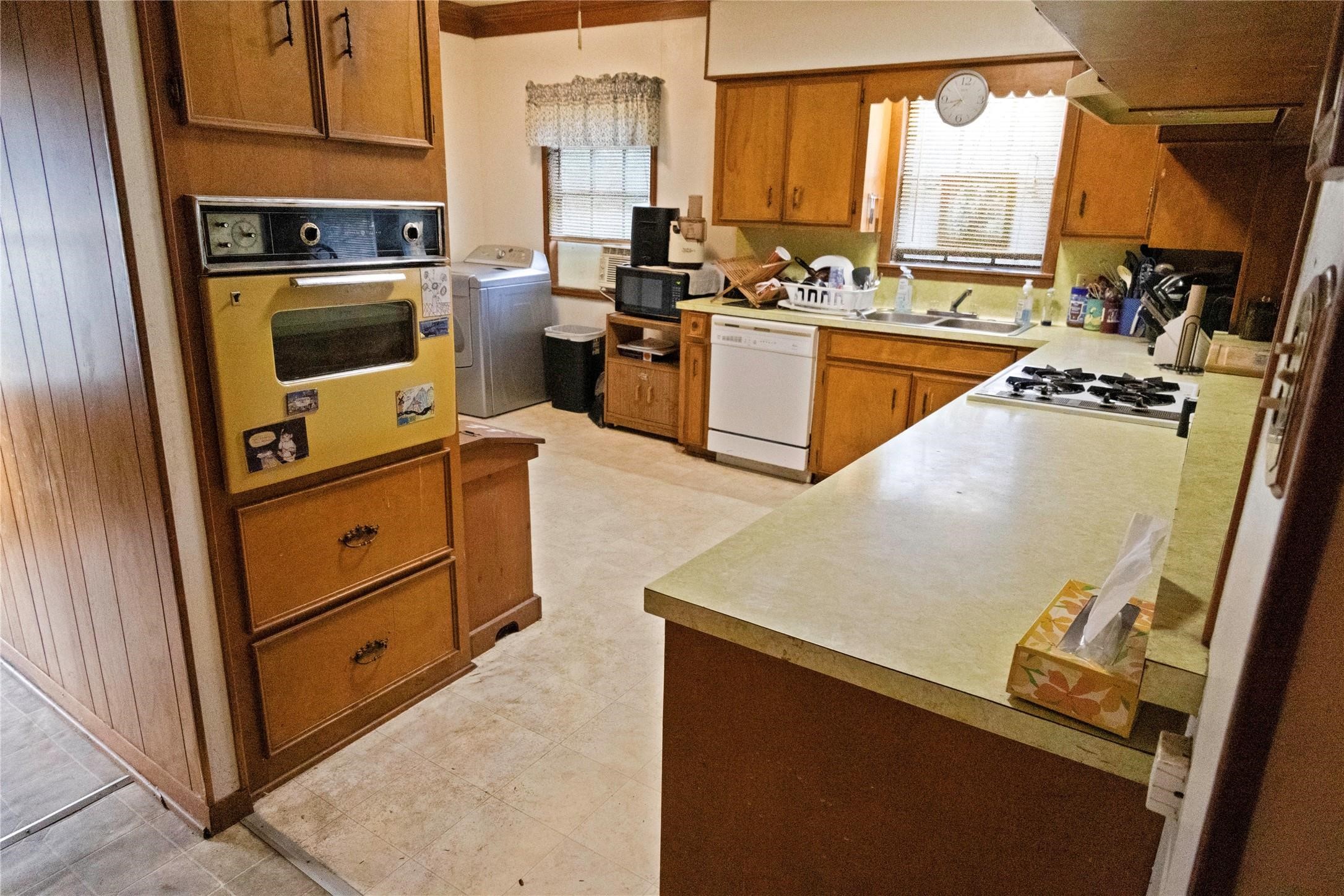 103 Birch Street Wallis, TX 77485 - Photo 8 of 11 a kitchen with a stove a sink and a microwave