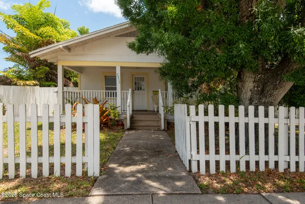 a view of a house with wooden fence