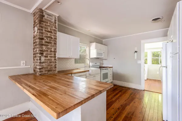 a room with lots of appliances and a rug