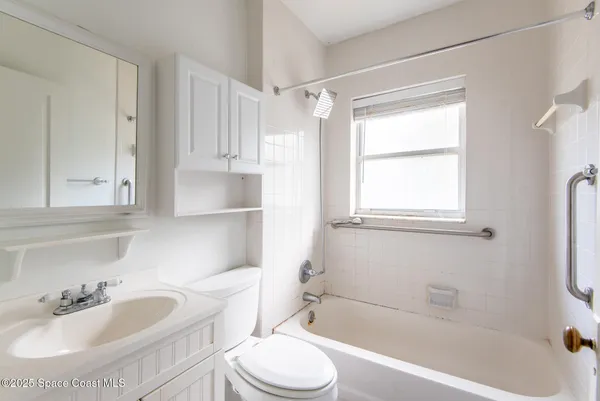 a bathroom with a sink toilet tub and shower