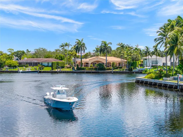 an aerial view of a house with a garden and lake view