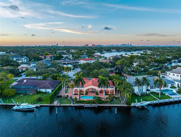 an aerial view of a houses with city and lake view
