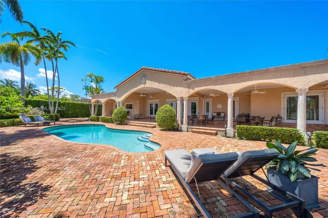 a view of house with swimming pool outdoor seating