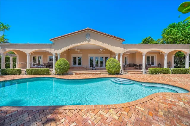 a view of a white house with a swimming pool