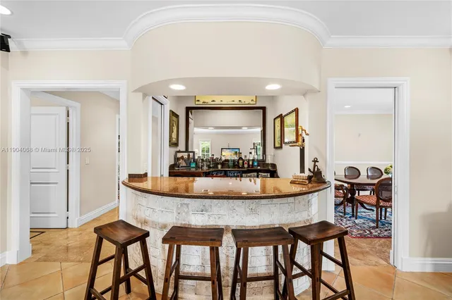a view of a dining room with furniture and a chandelier