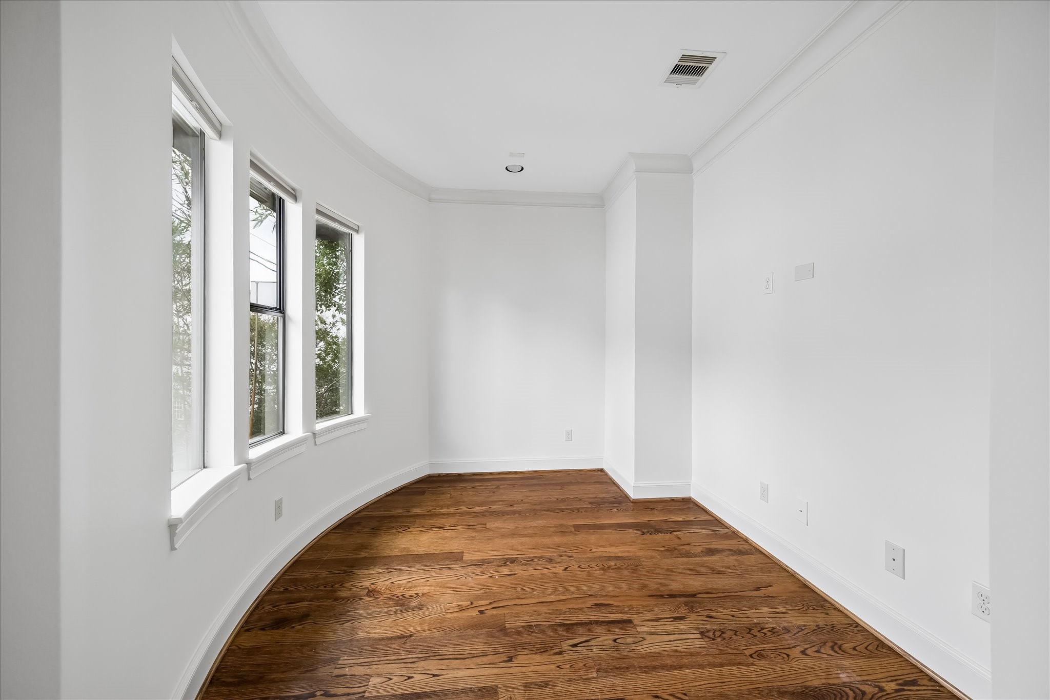 2246 Branard Street Houston, TX 77098 - Photo 25 of 40 A versatile bonus space off the primary suite with curved windows, abundant natural light, and rich hardwood floors—ideal for a sitting room, office, or fitness area.