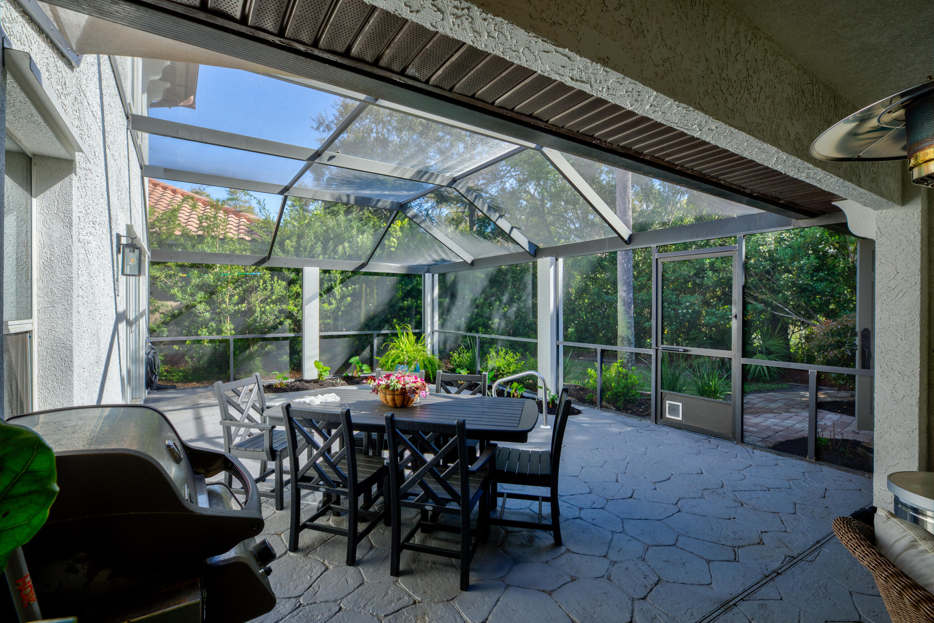 4639 Paradise Isle Destin, FL 32541 - Photo 13 of 67 a view of a patio with chairs and table under an umbrella