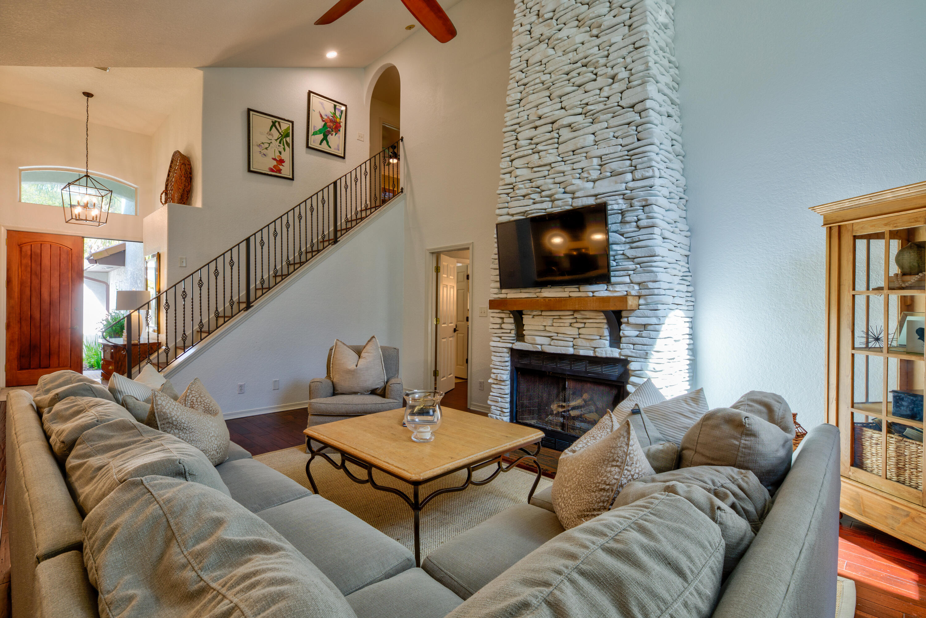 4639 Paradise Isle Destin, FL 32541 - Photo 20 of 67 a living room with furniture a fireplace and a flat screen tv