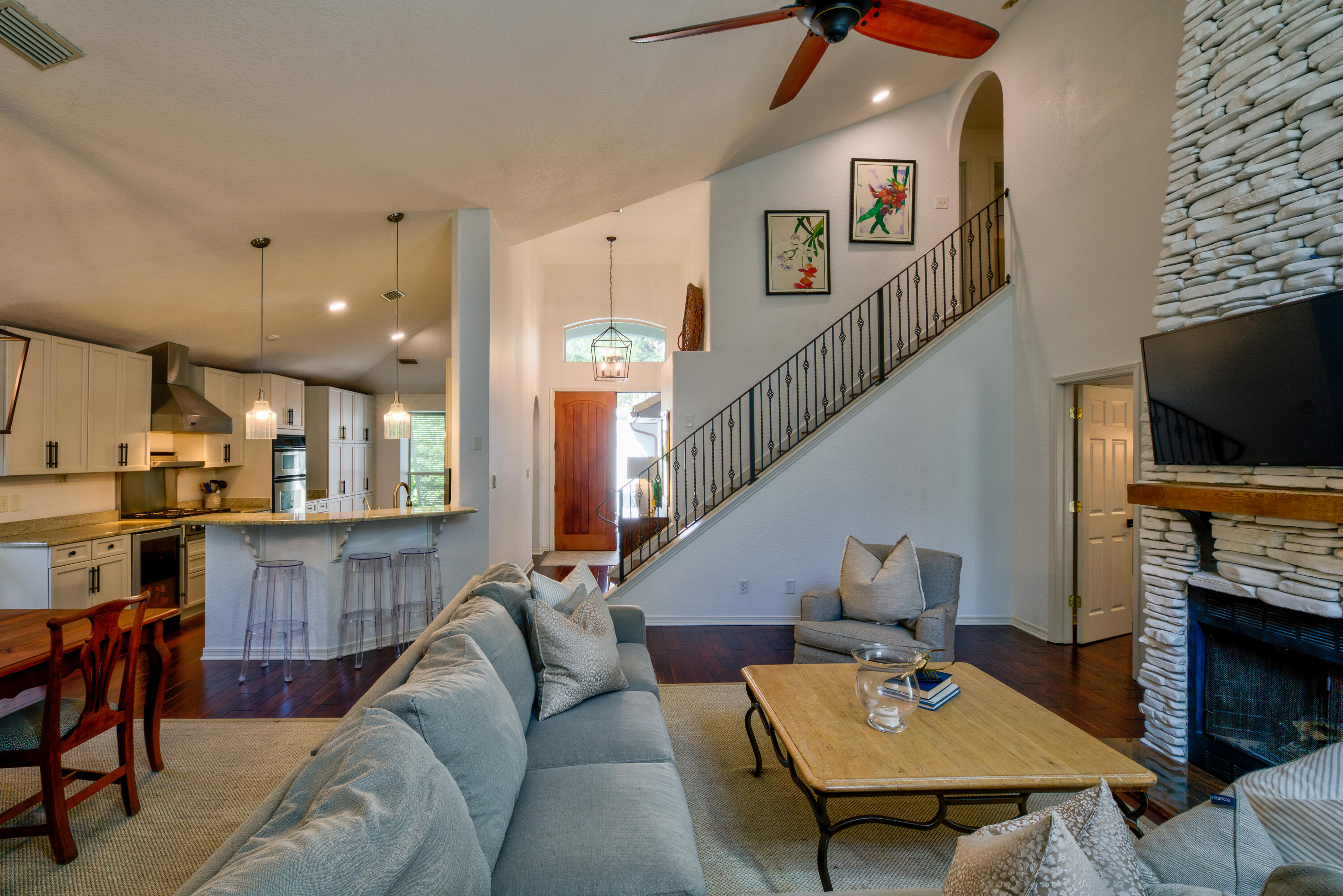 4639 Paradise Isle Destin, FL 32541 - Photo 22 of 67 a living room with furniture a flat screen tv and kitchen view