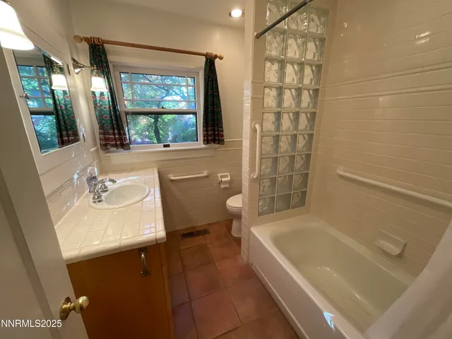 a view of a hallway with wooden floor and stairs