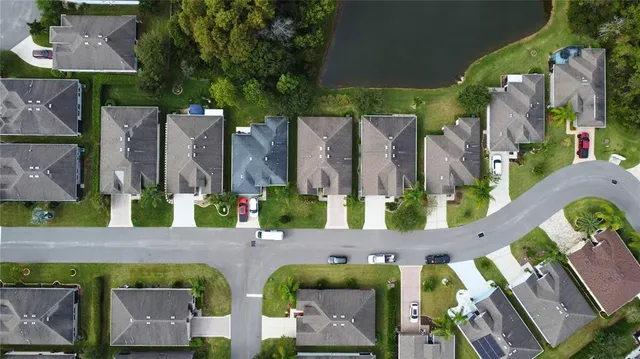 an aerial view of multiple houses with a yard
