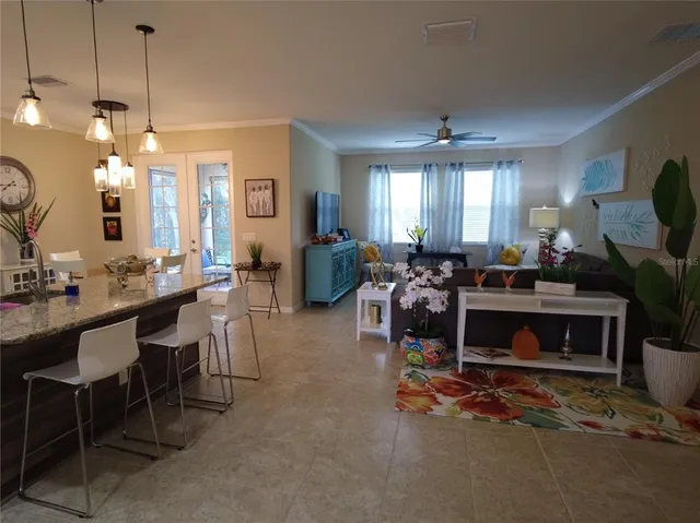 a living room with furniture a fireplace and a chandelier