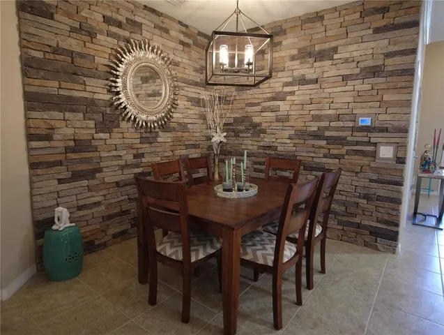 a dining room with a wooden table and chairs