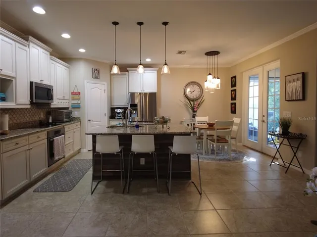 a large kitchen with a table and chairs