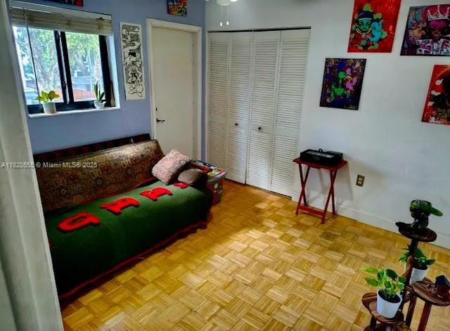 a bedroom with a bed and a painting on the wall