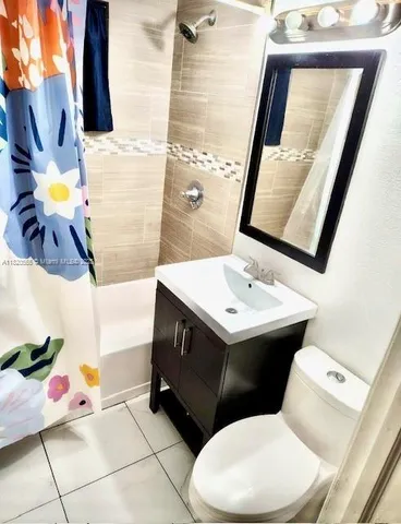a bathroom with a sink mirror and toilet