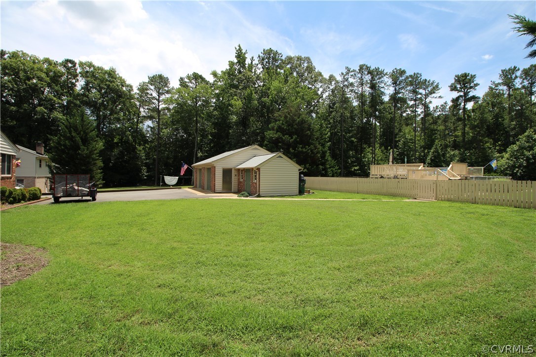 14111 Puritan Road Chesterfield, VA 23838 - Photo 38 of 49 a house view with swimming pool and trees in the background
