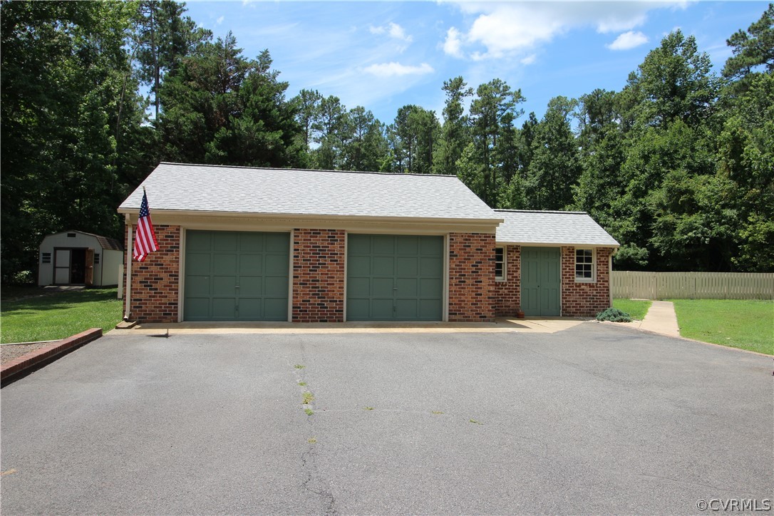 14111 Puritan Road Chesterfield, VA 23838 - Photo 4 of 49 a front view of a house with a yard and garage