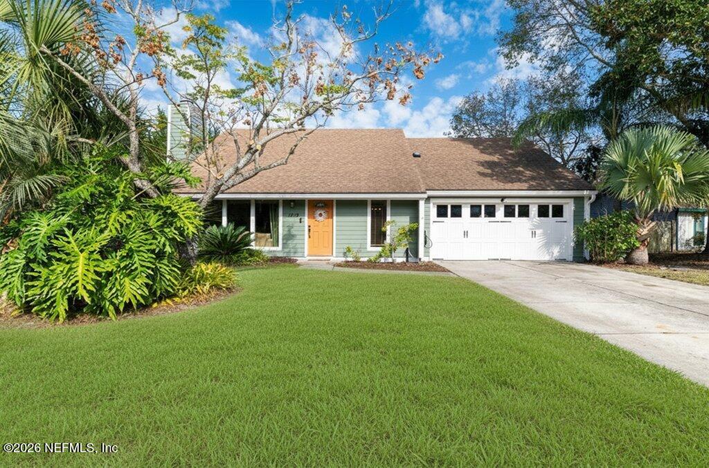 a view of house with yard and green space