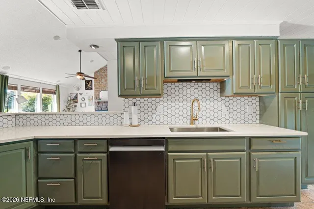 a kitchen with a sink and cabinets