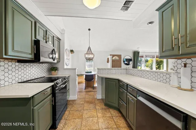 a kitchen with granite countertop a sink a stove and cabinets