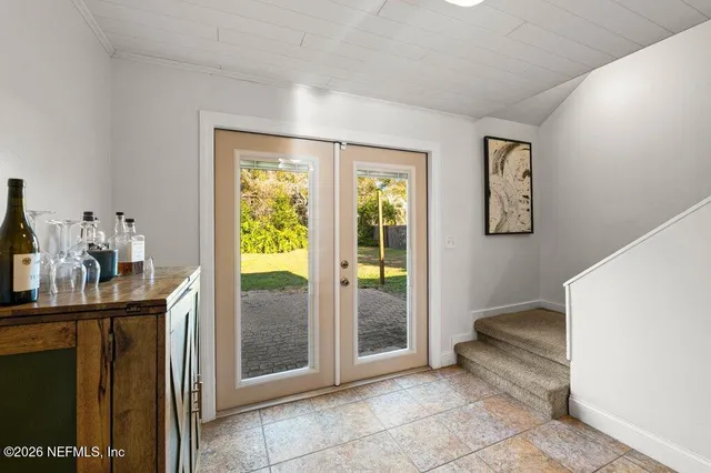 a view of a hallway with bathroom and glass door