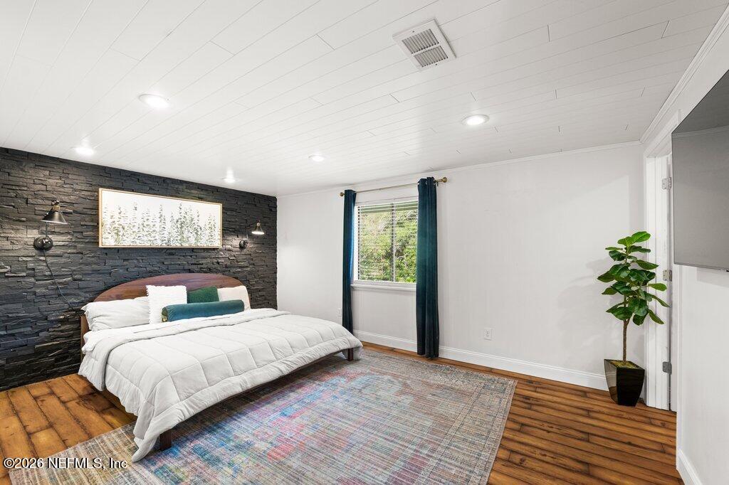 1810 Kings Way Neptune Beach, FL 32266 - Photo 15 of 40 a bedroom with a large bed and a potted plant