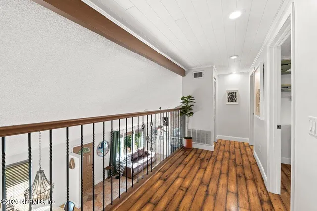 a view of hallway with wooden floor