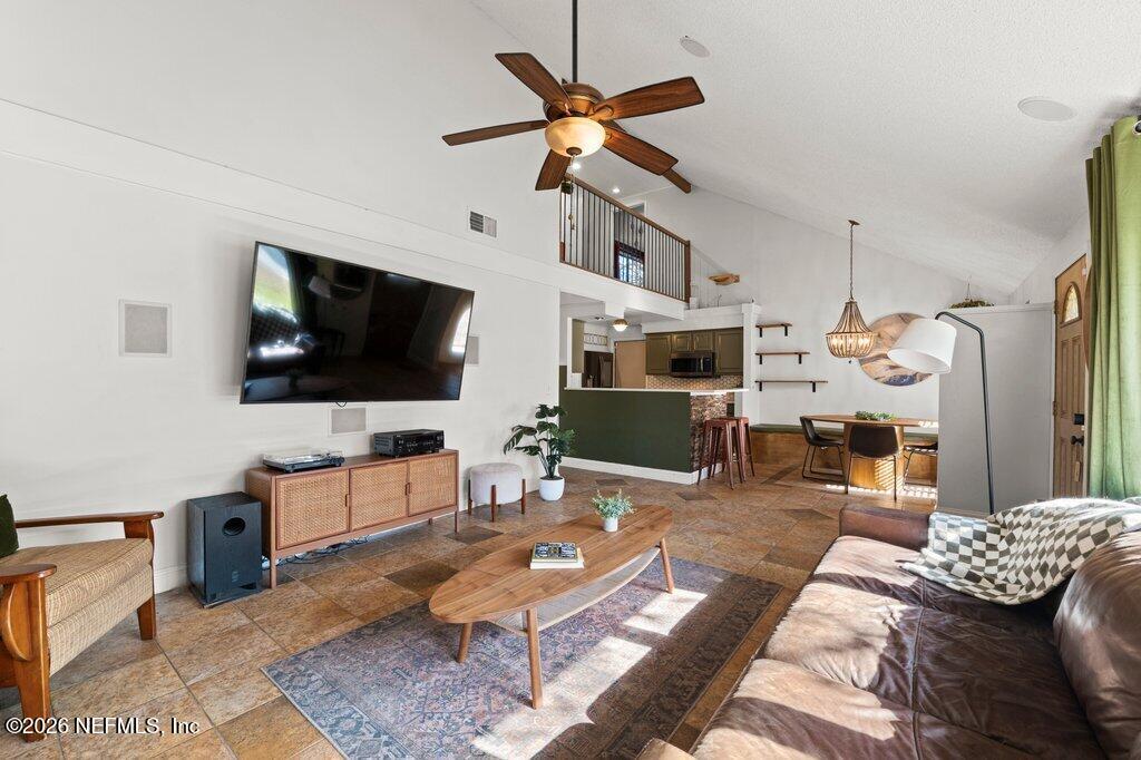 1810 Kings Way Neptune Beach, FL 32266 - Photo 5 of 40 a living room with furniture a flat screen tv and kitchen view