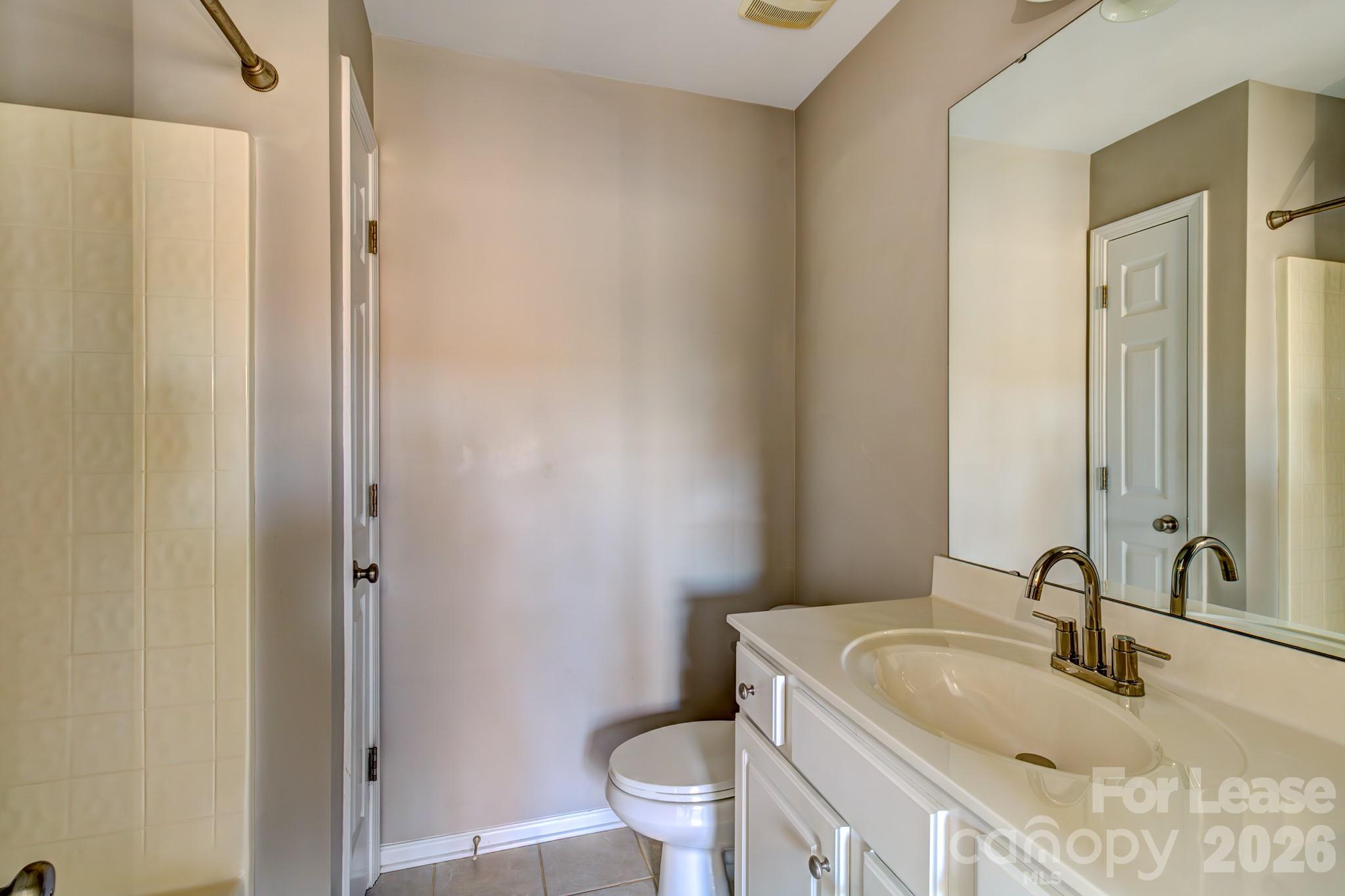 417 River Park Road Belmont, NC 28012 - Photo 12 of 16 a bathroom with a granite countertop sink toilet and a mirror