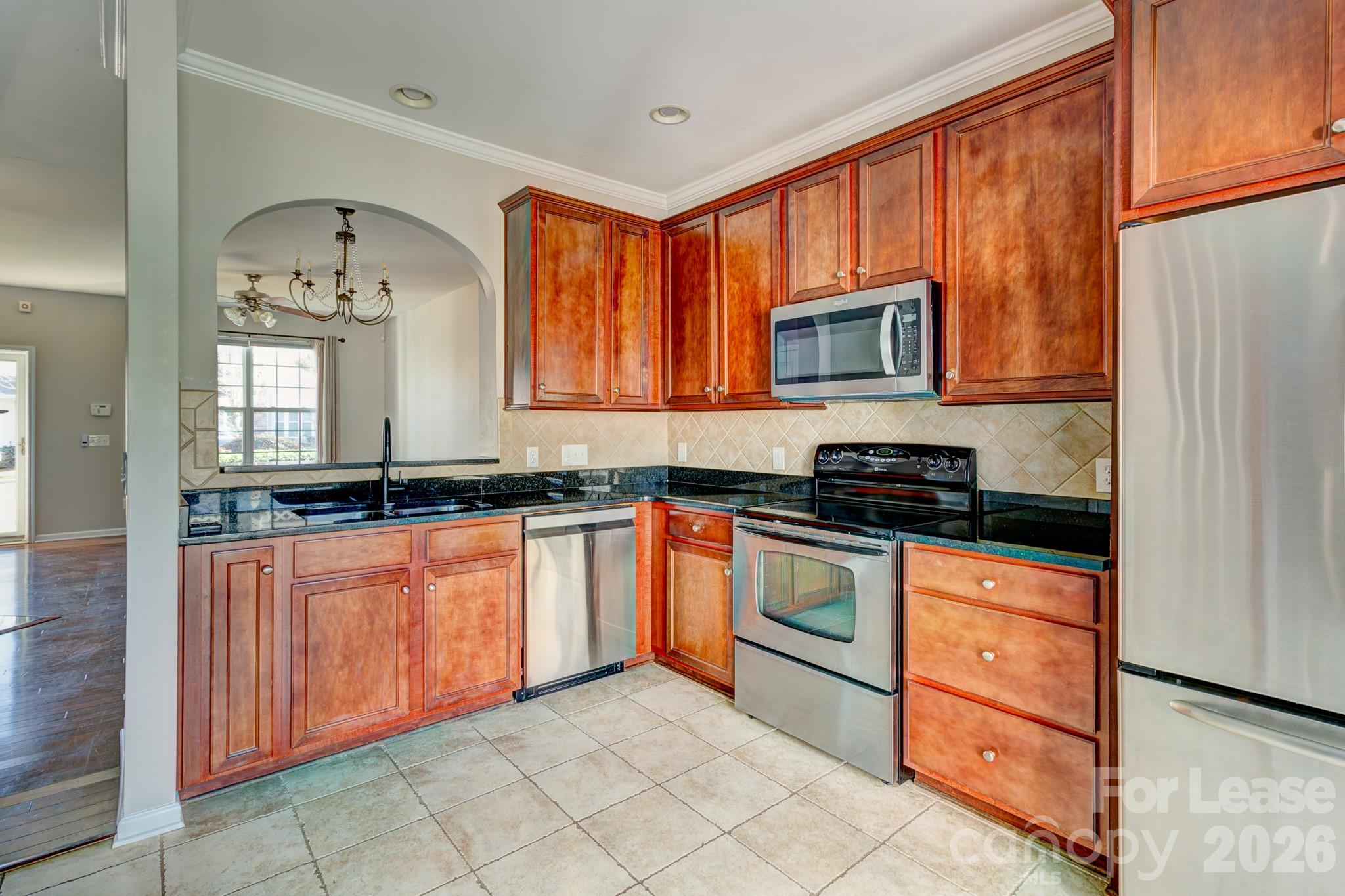 417 River Park Road Belmont, NC 28012 - Photo 5 of 16 a kitchen with stainless steel appliances granite countertop a stove a sink and a microwave