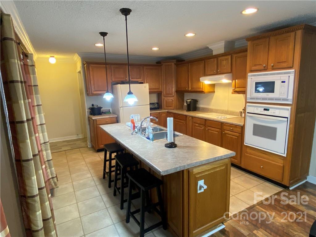 295 Bar Link Road Mount Pleasant, NC 28124 - Photo 12 of 29 a kitchen with stainless steel appliances granite countertop a sink a stove and a refrigerator