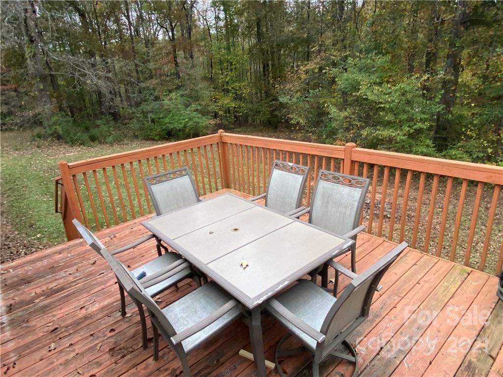 295 Bar Link Road Mount Pleasant, NC 28124 - Photo 7 of 29 a view of a balcony with wooden floor and outdoor seating