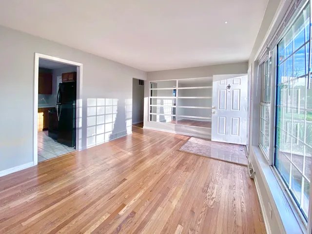 a view of wooden floor and windows in a room