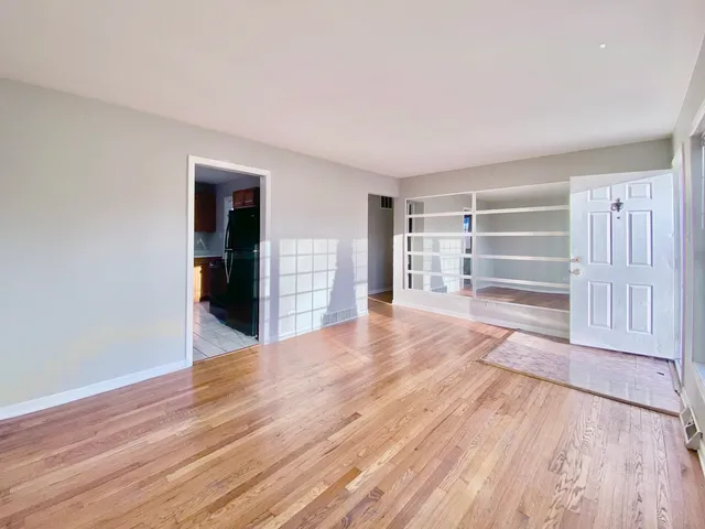 a room with wooden floors and stairs