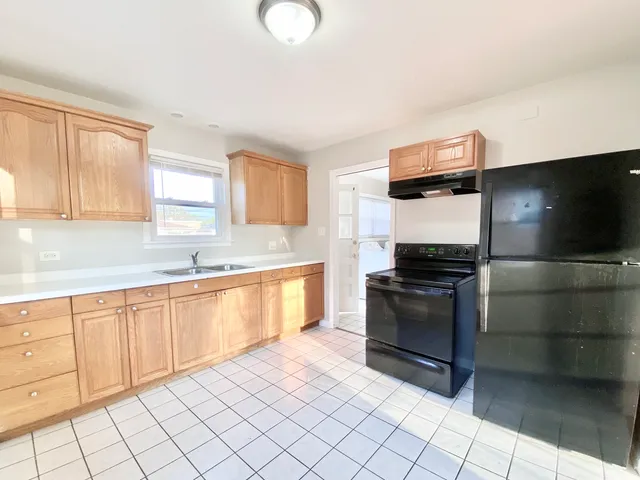 a kitchen with stainless steel appliances granite countertop a sink and a stove