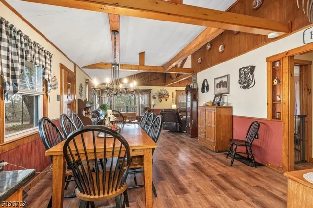 a dining room with furniture and wooden floor