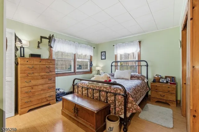 a bedroom with a bed and windows