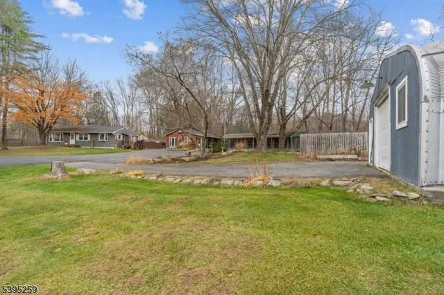 a view of a house with a yard covered in snow