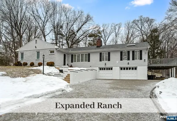 a front view of a house with a yard covered with snow in the outdoor space