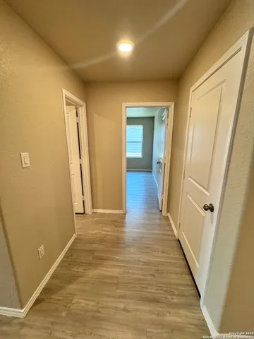 a view of a hallway with wooden floor