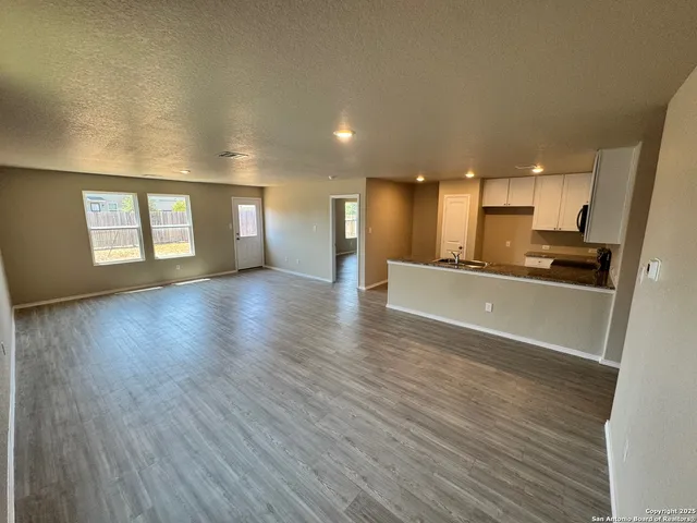 a view of a kitchen with a sink and a window