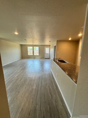 a view of hallway with wooden floor