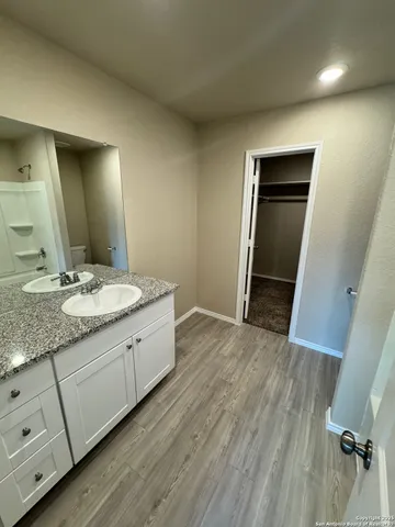 a bathroom with a granite countertop sink and mirror