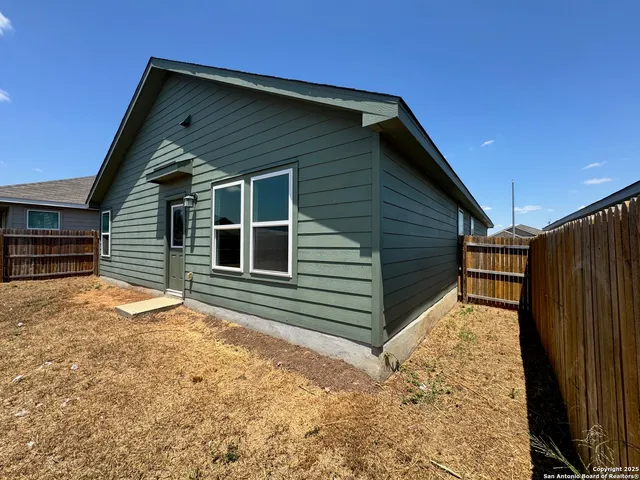 a view of backyard with a large tree