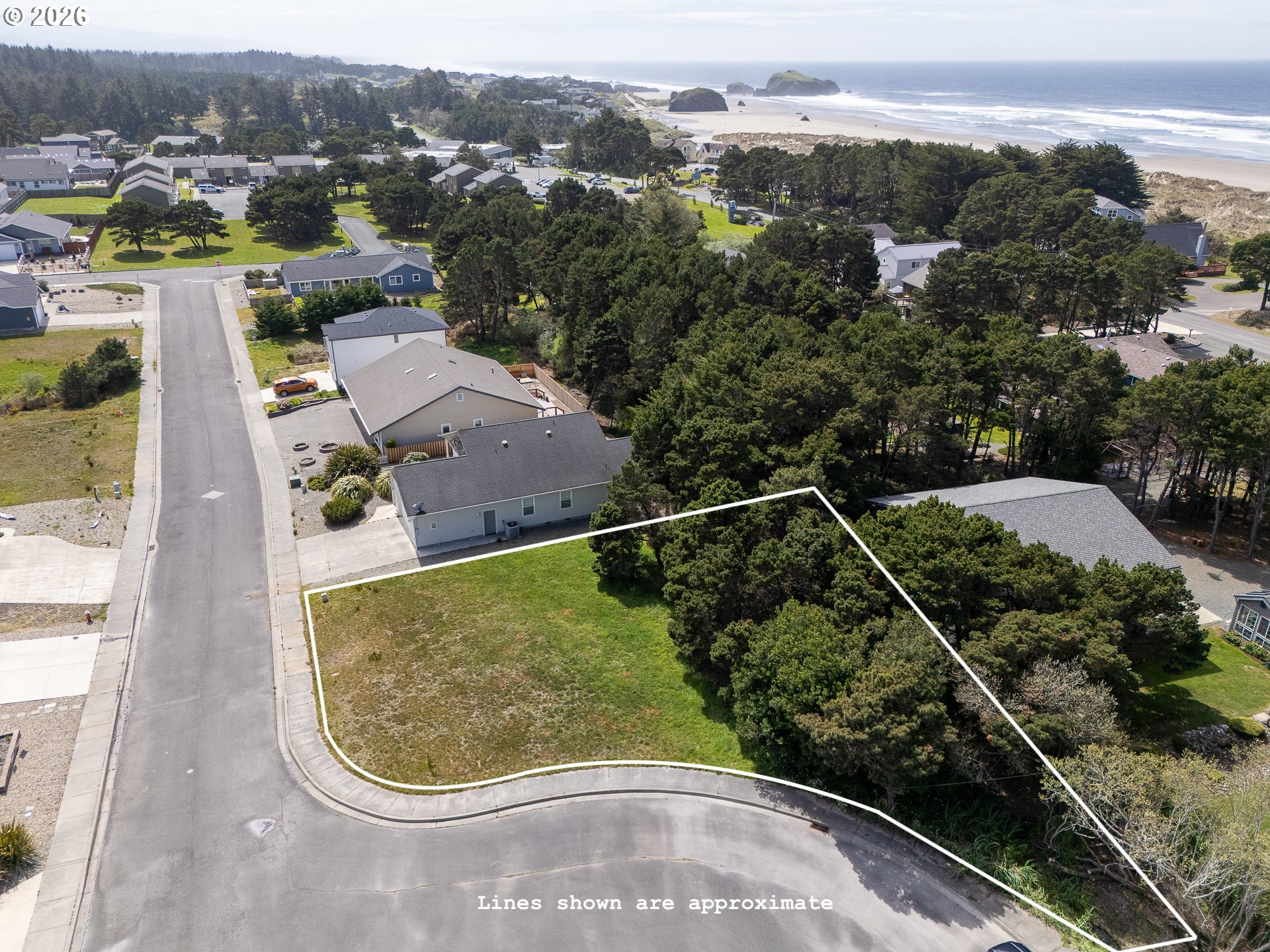 3122 Periwinkle Lane Southwest, Unit 5 Bandon, OR 97411 - Photo 1 of 13 an aerial view of a house with a yard and lake view