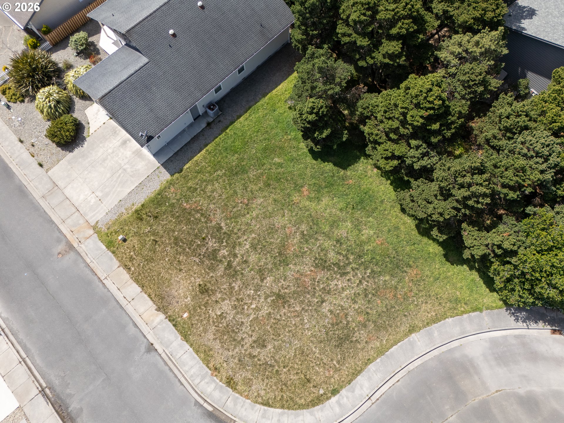 3122 Periwinkle Lane Southwest, Unit 5 Bandon, OR 97411 - Photo 10 of 13 a view of a backyard