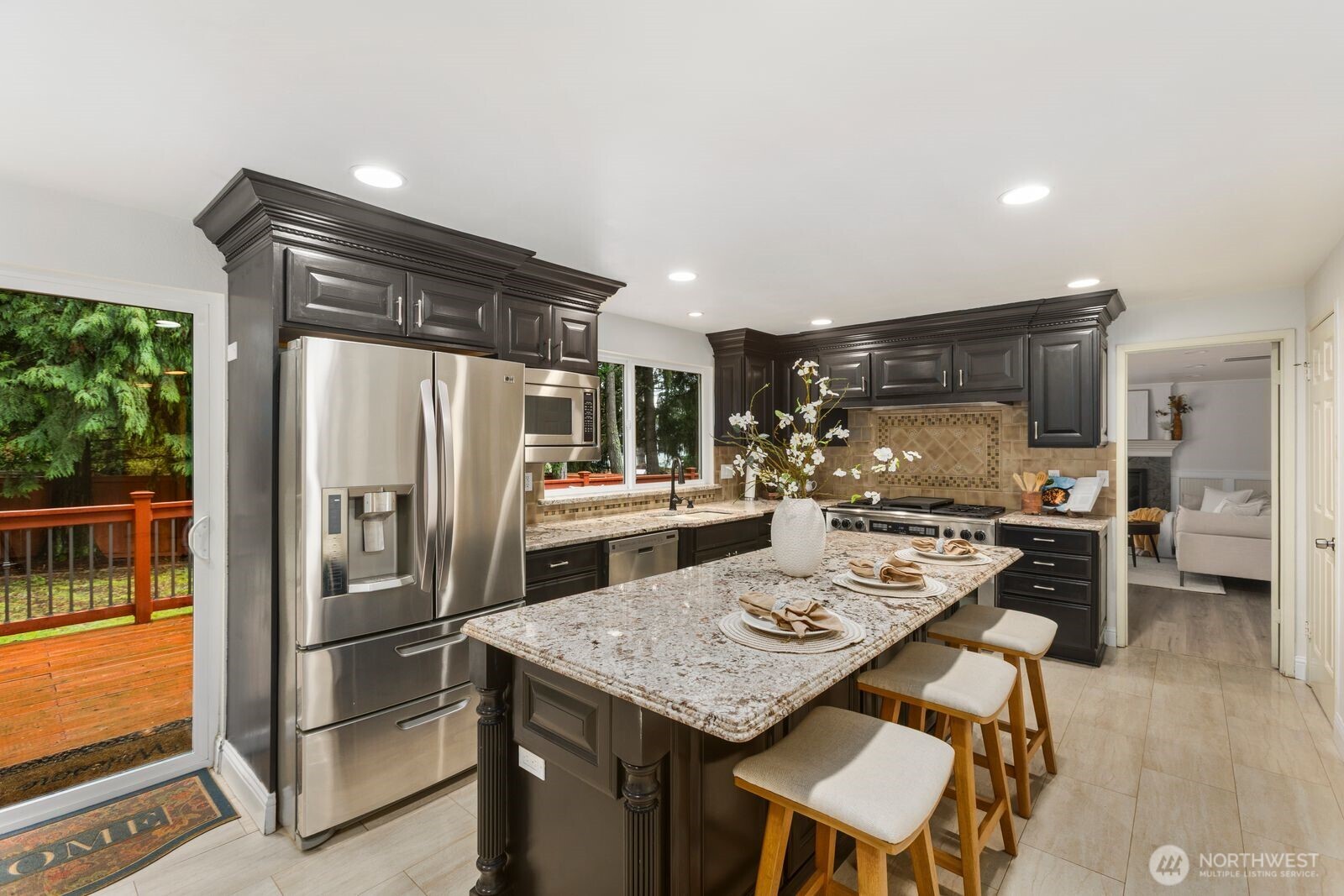18505 Northeast 26th Street Redmond, WA 98052 - Photo 12 of 38 a kitchen with refrigerator and chairs
