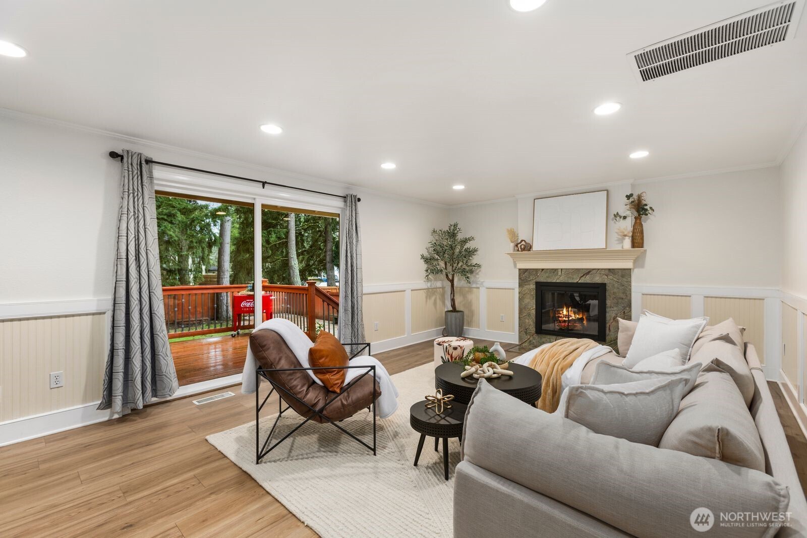 18505 Northeast 26th Street Redmond, WA 98052 - Photo 16 of 38 a living room with furniture a fireplace and a floor to ceiling window