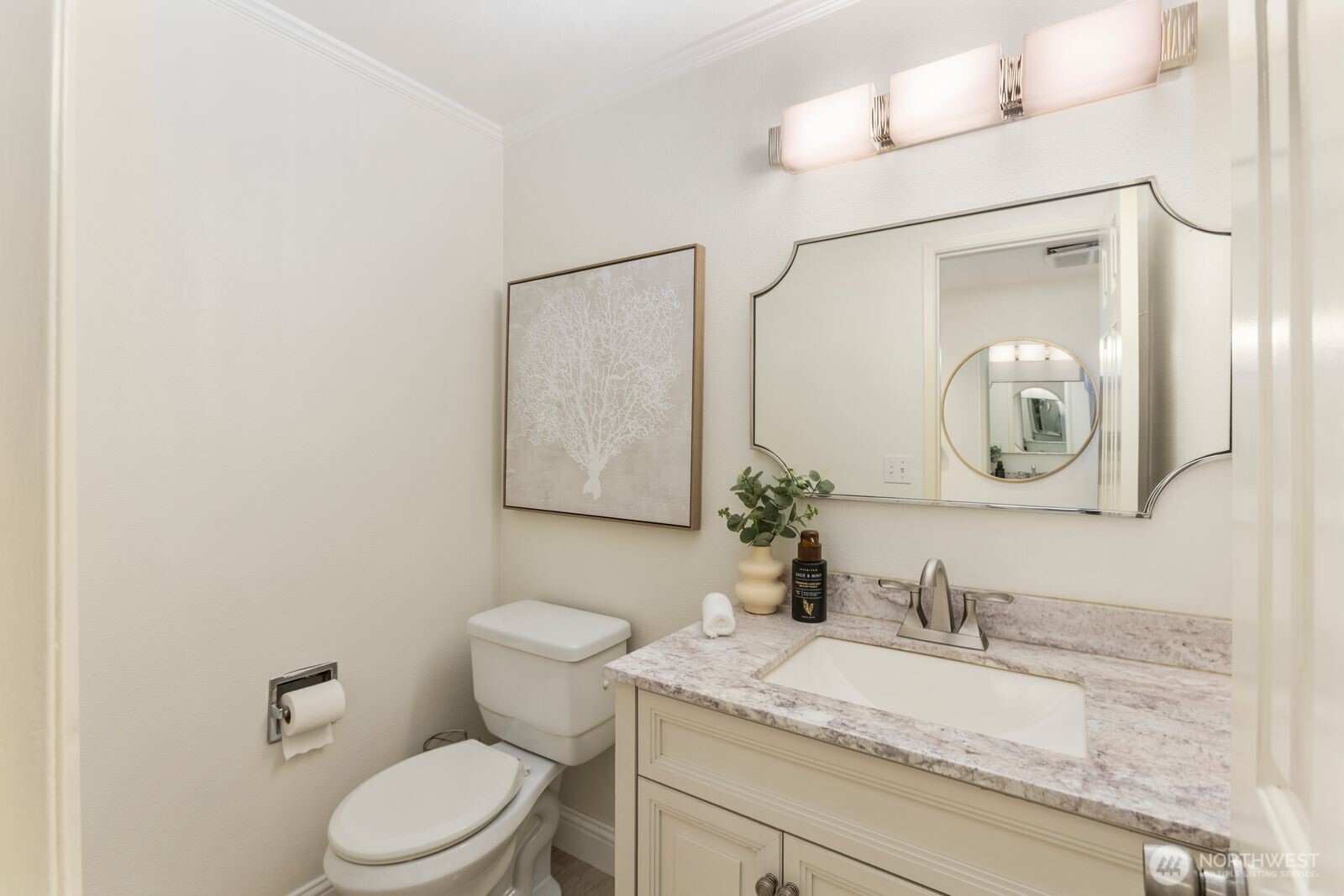 18505 Northeast 26th Street Redmond, WA 98052 - Photo 19 of 38 a bathroom with a granite countertop sink mirror vanity and toilet